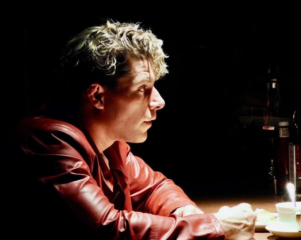 Travis acting with dramatic lighting