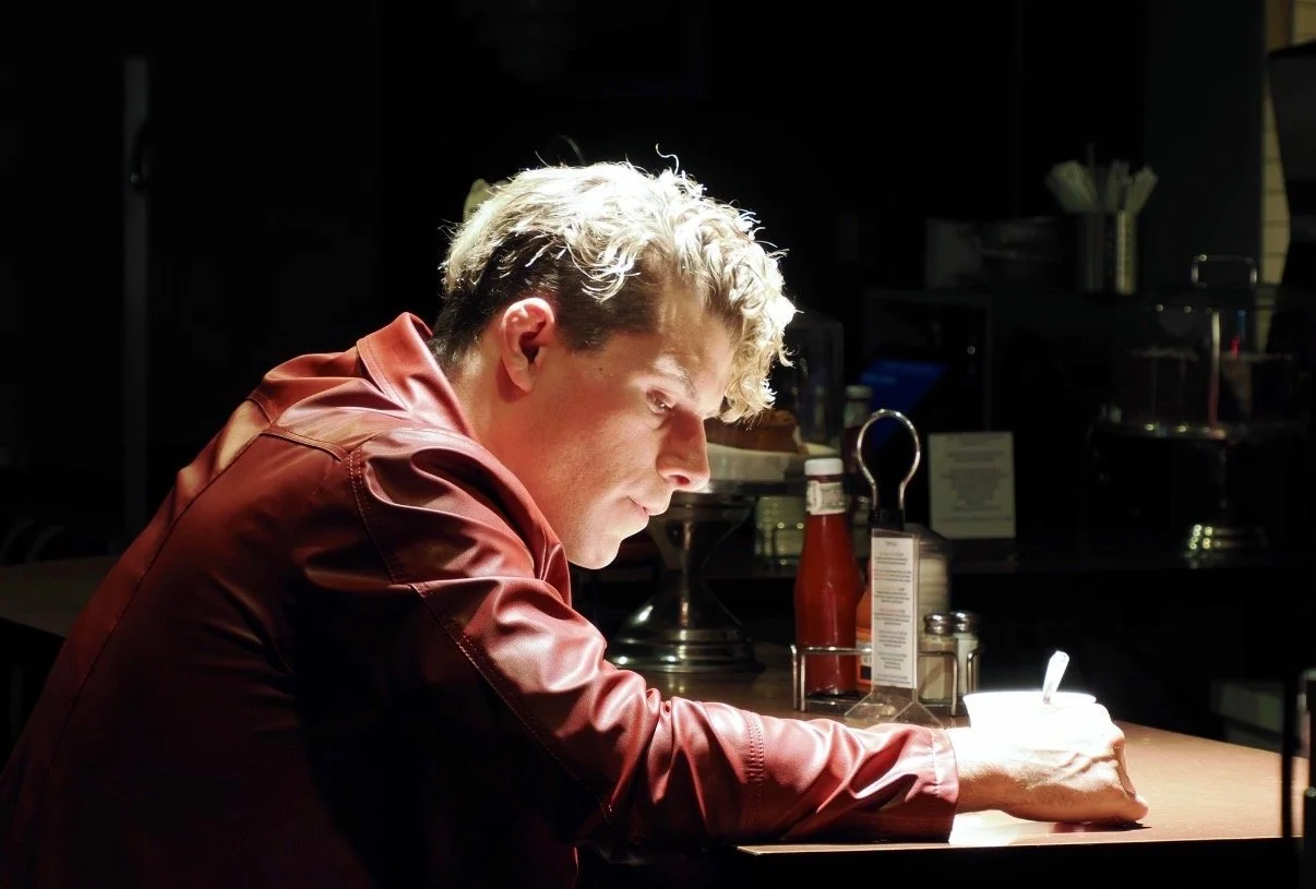 Travis acting at a bar pondering things