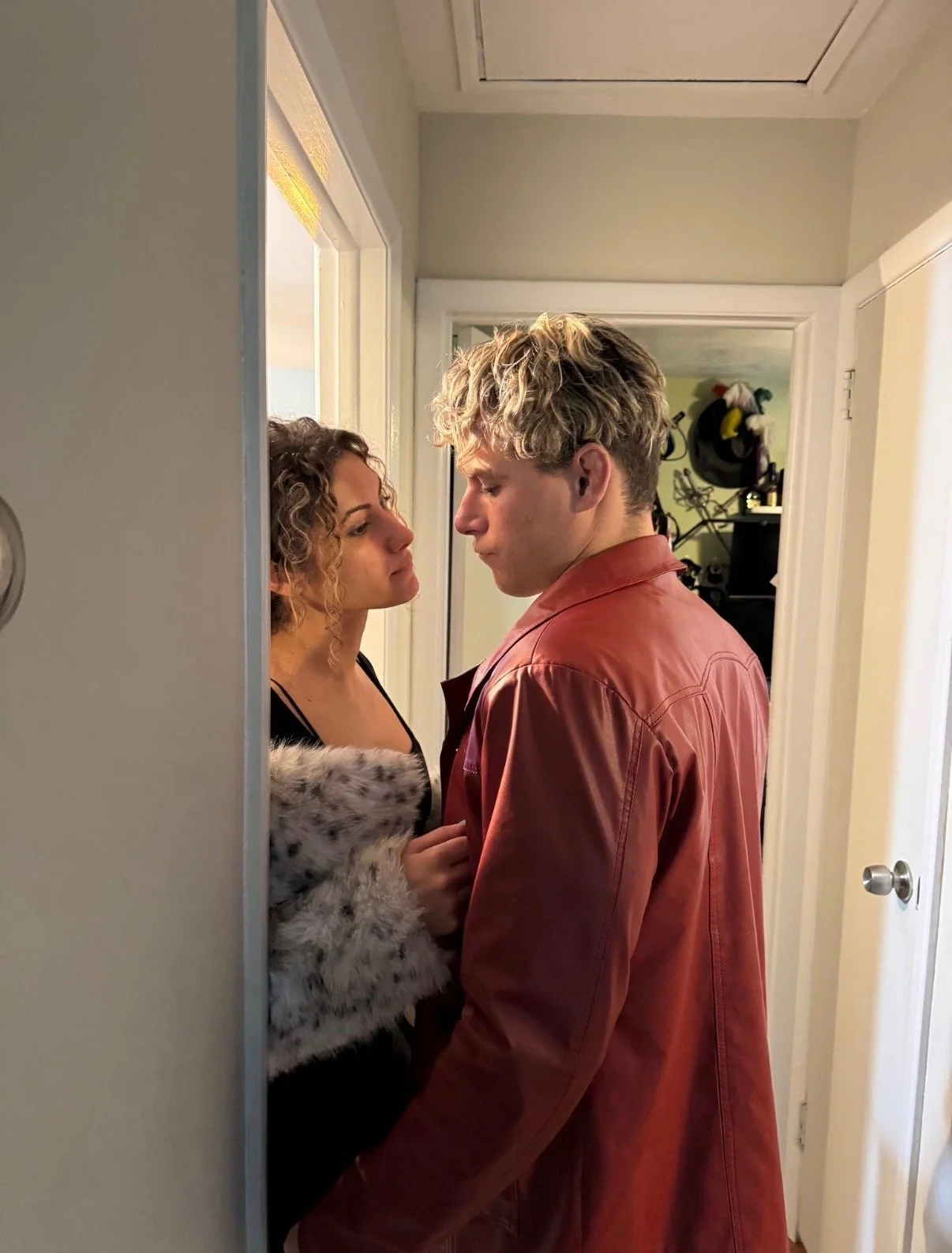 Travis acting in a doorway getting a woman into his apartment