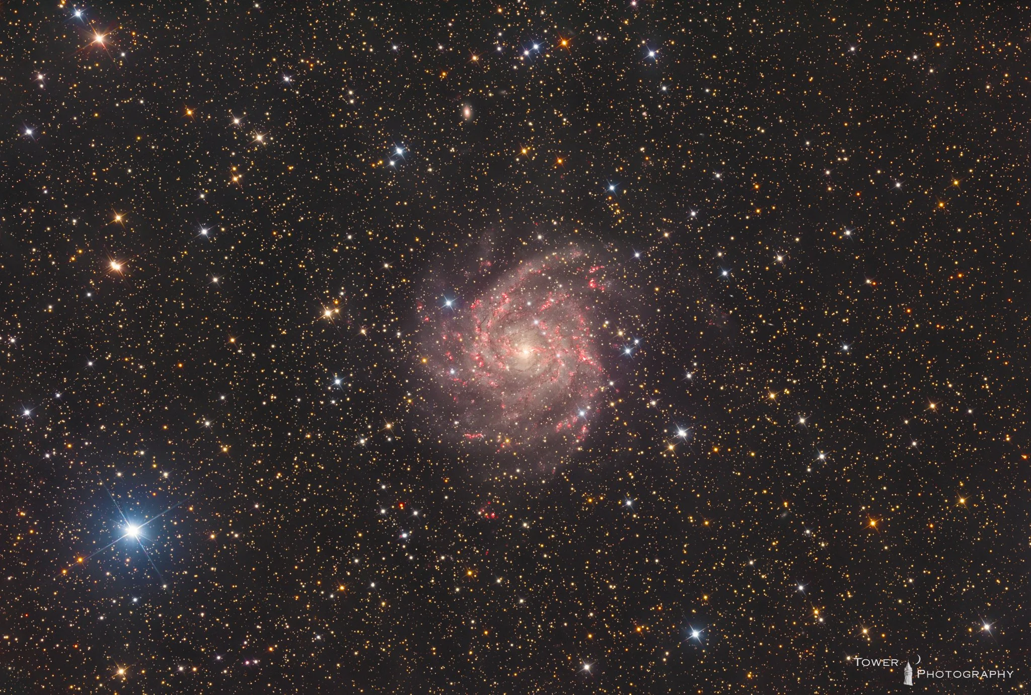 Deep space image of a galaxy surrounded by numerous stars and celestial objects