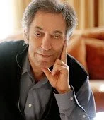 Author LARRY GELLER, resting his chin on his hand, looking at the camera.