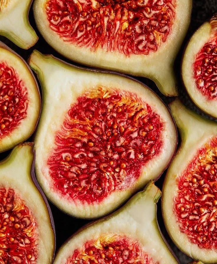 Close-up of sliced fresh figs showing red interior with seeds.