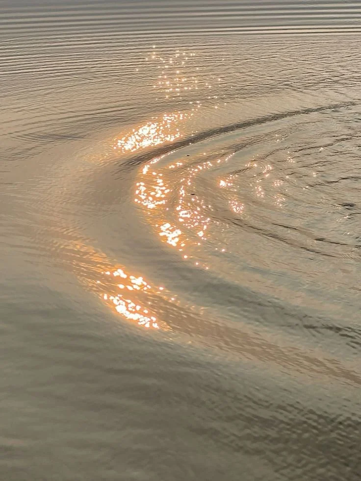 Sunlight reflecting on rippling water in a lake or ocean.