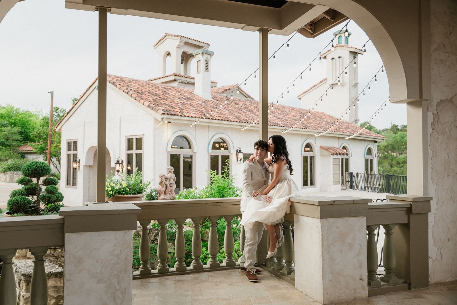 Bride kisses groom at Villa Antonia wedding in Austin