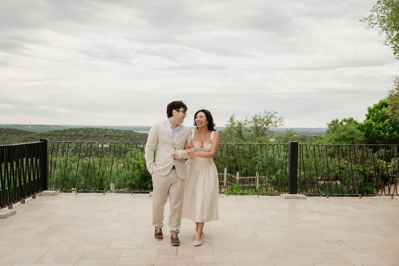 Bride and groom walk on balcony at Villa Antonia wedding