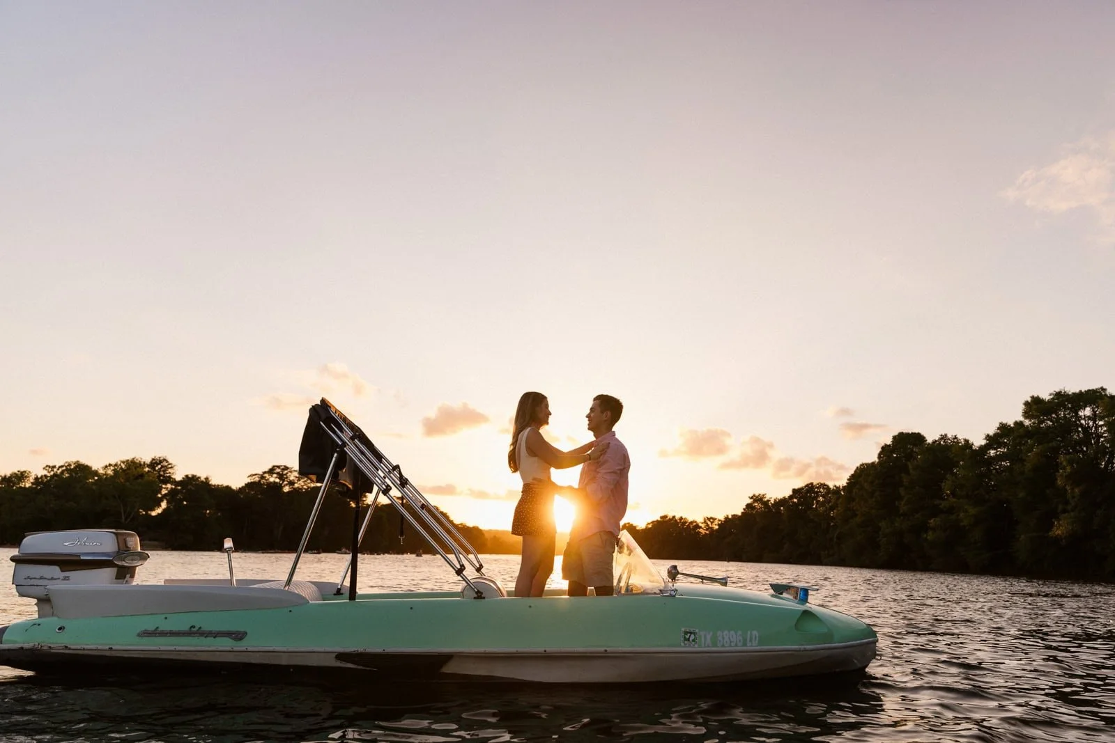 A couple on a boat at sunset on lake travis
