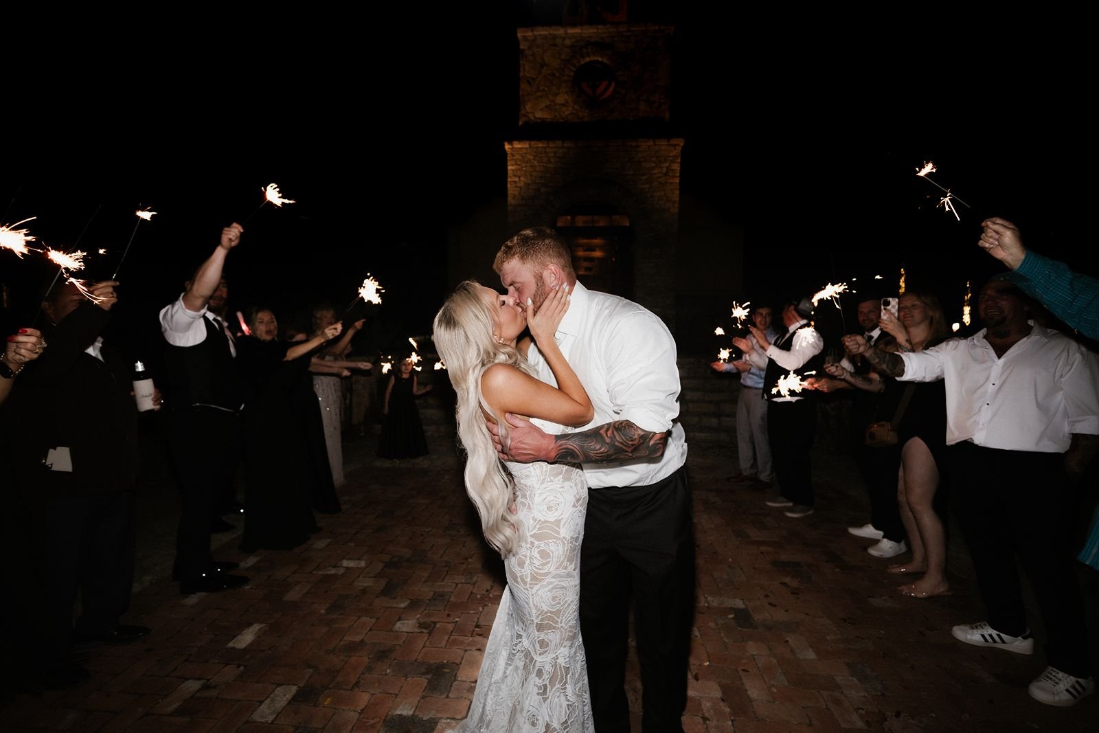 Newlyweds kiss to sparkler exit from Camp Lucy