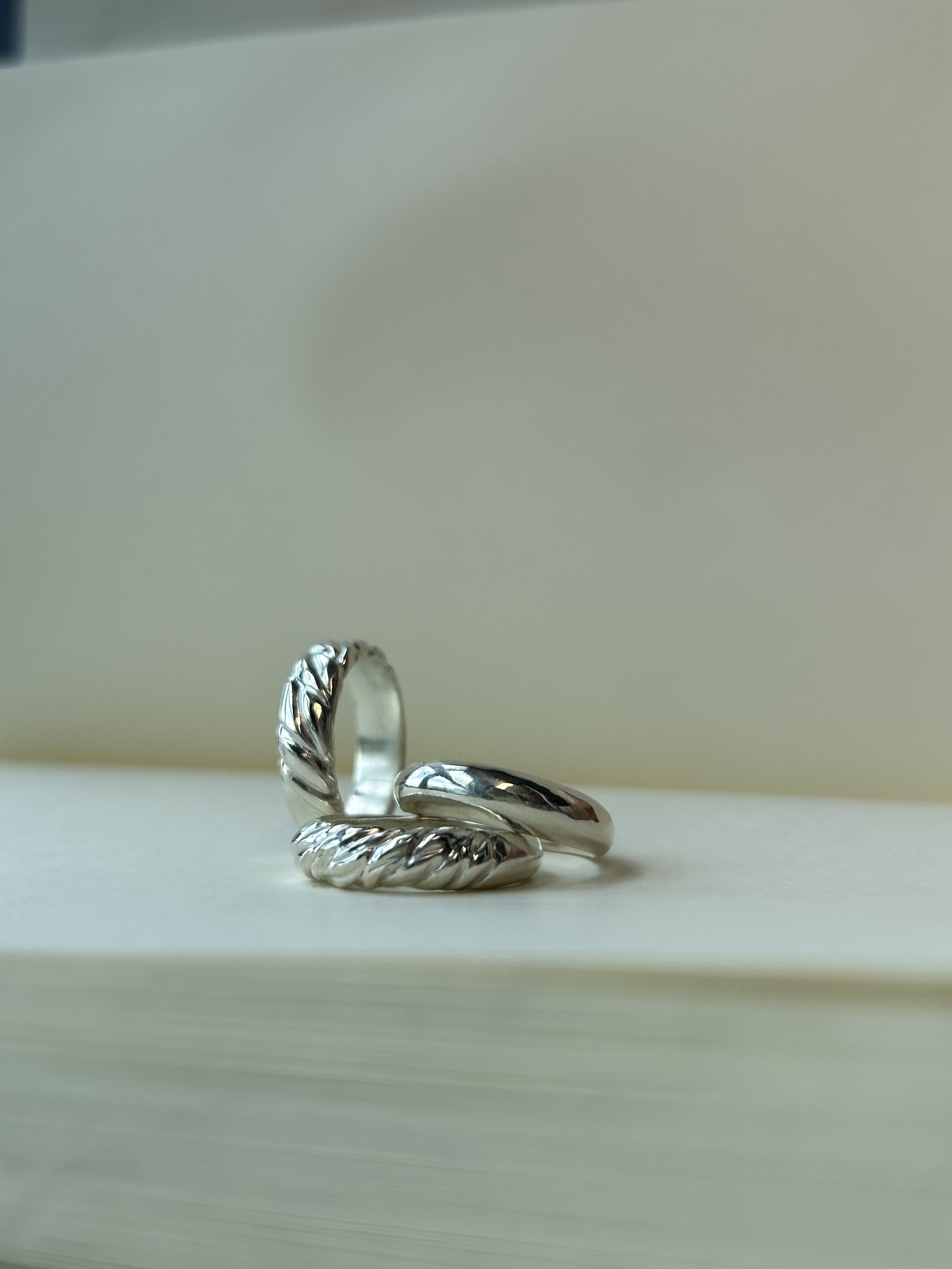 The Daring - a textured and tapered sterling silver ring with the two other sterling silver ring from The First Collection