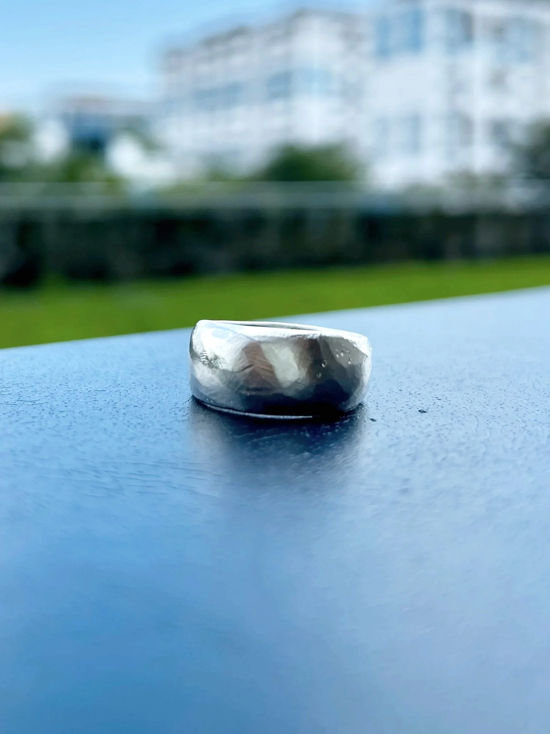 A sterling silver ring with hammered texture mimicked by wax carving