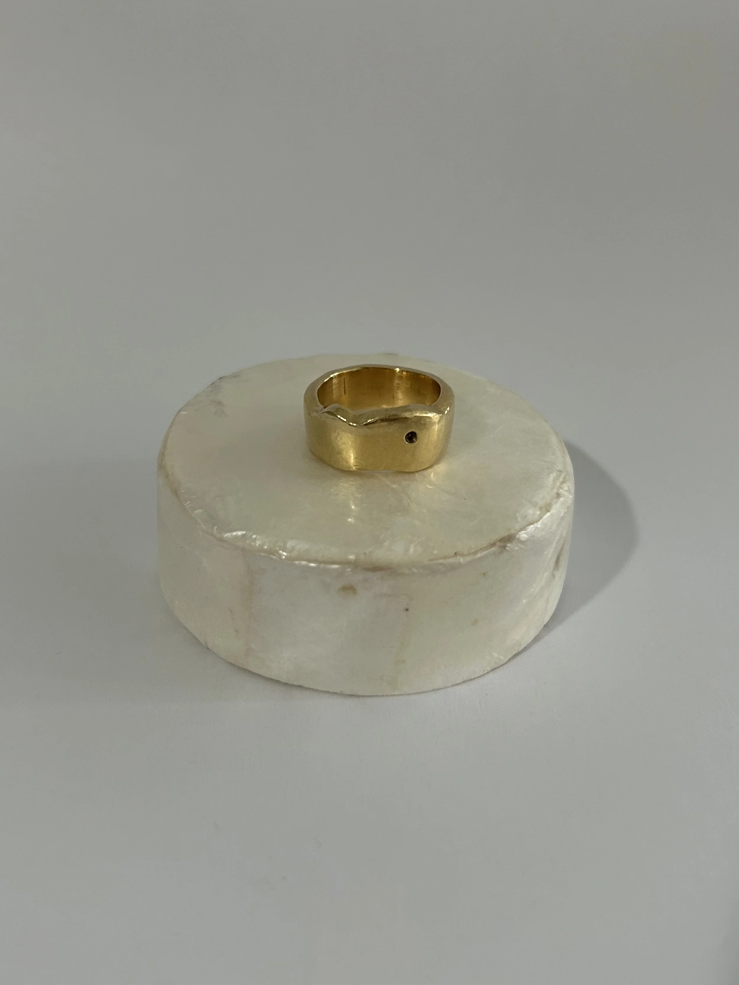 An 18k gold ring carved from the image of a bump.