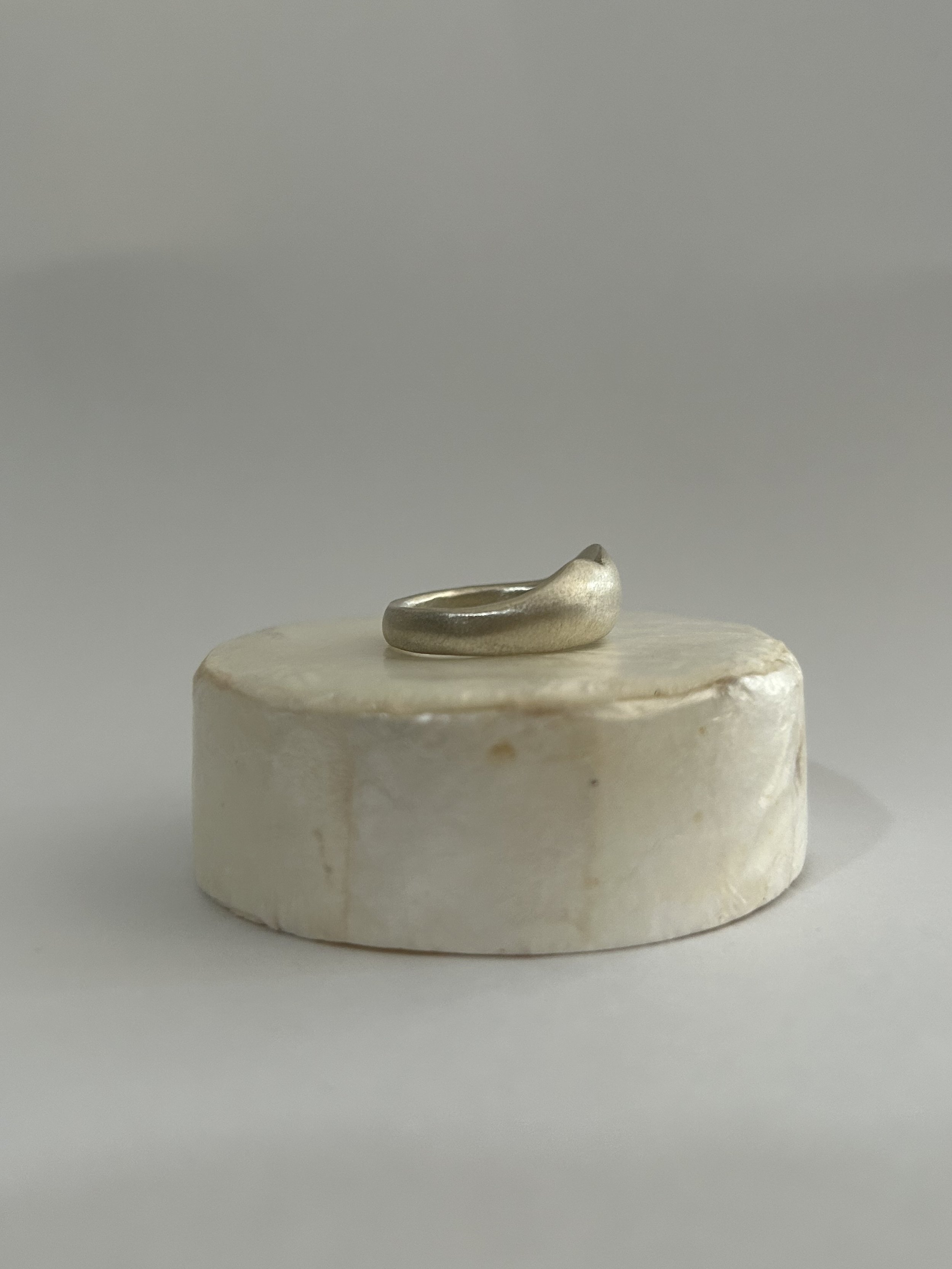 A sterling silver ring carved as a variation to the gold bump ring