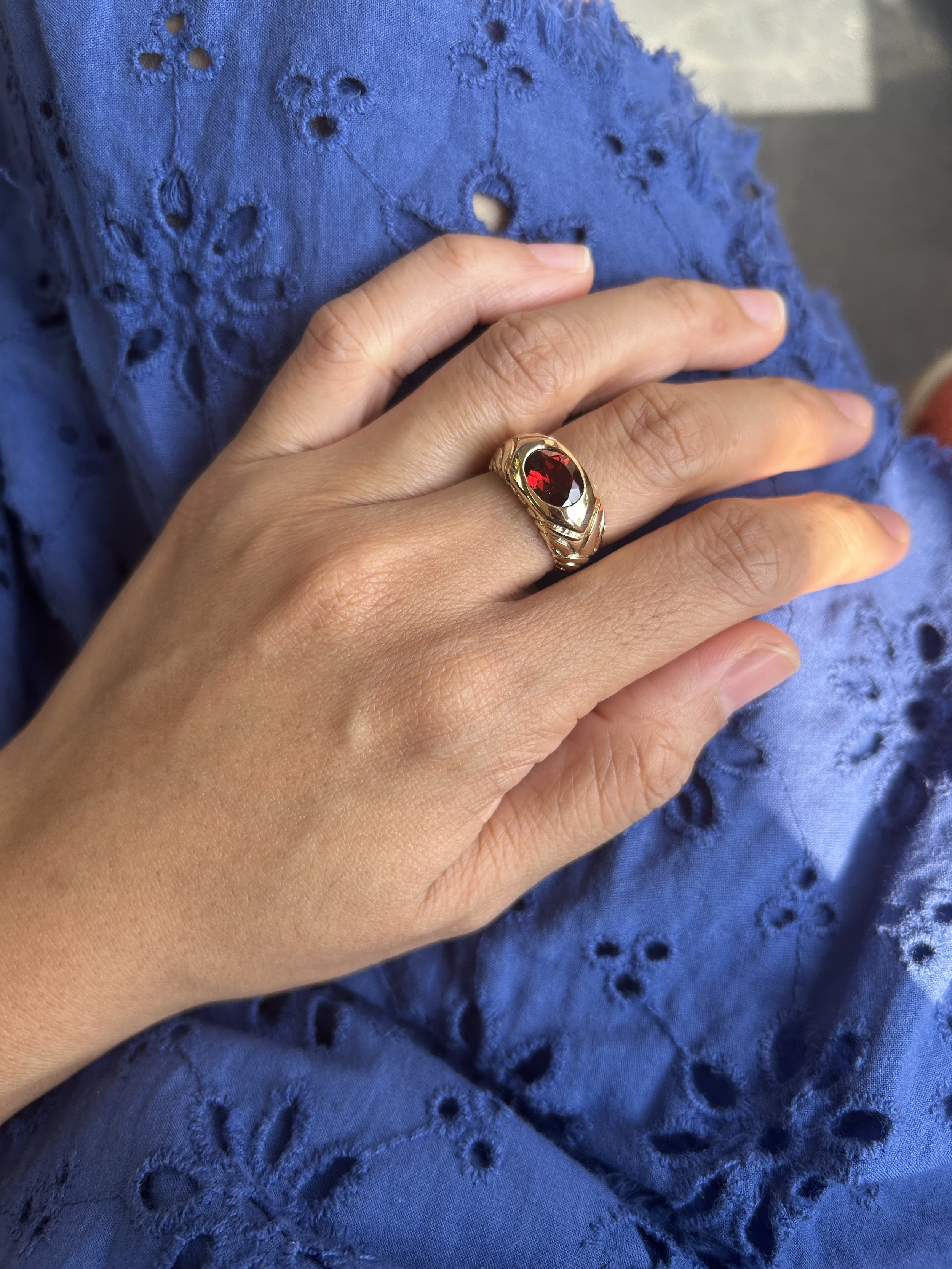 An 18k gold ring with garnet carved in wax and casted using recycled pieces