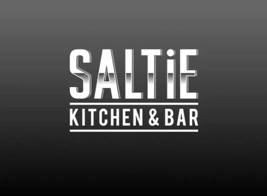 Logo for Saltie Kitchen & Bar in white text on a dark gradient background.