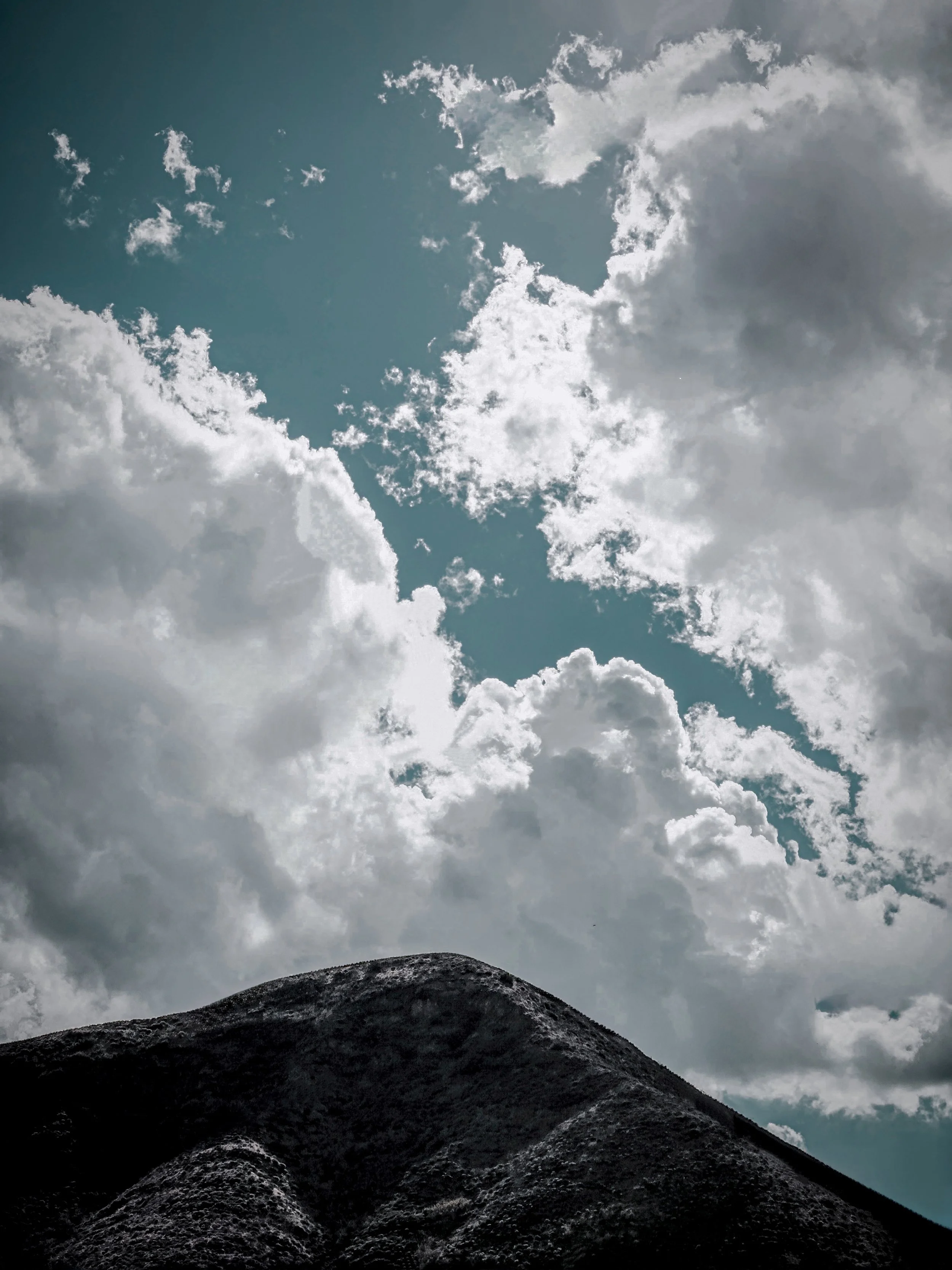 Cloudy sky with dark mountians with some beautiful sunlight light.