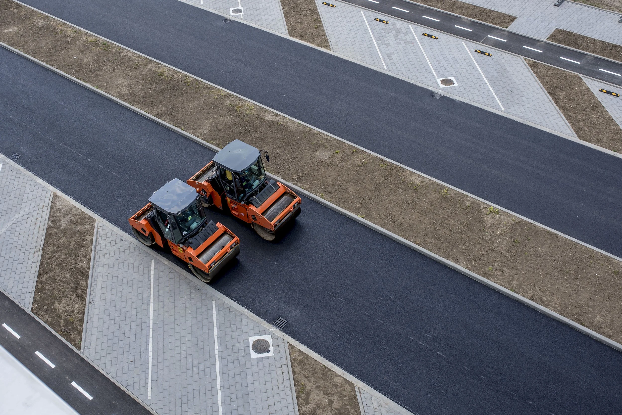 New asphalt being laid with an asphalt roller and compactor