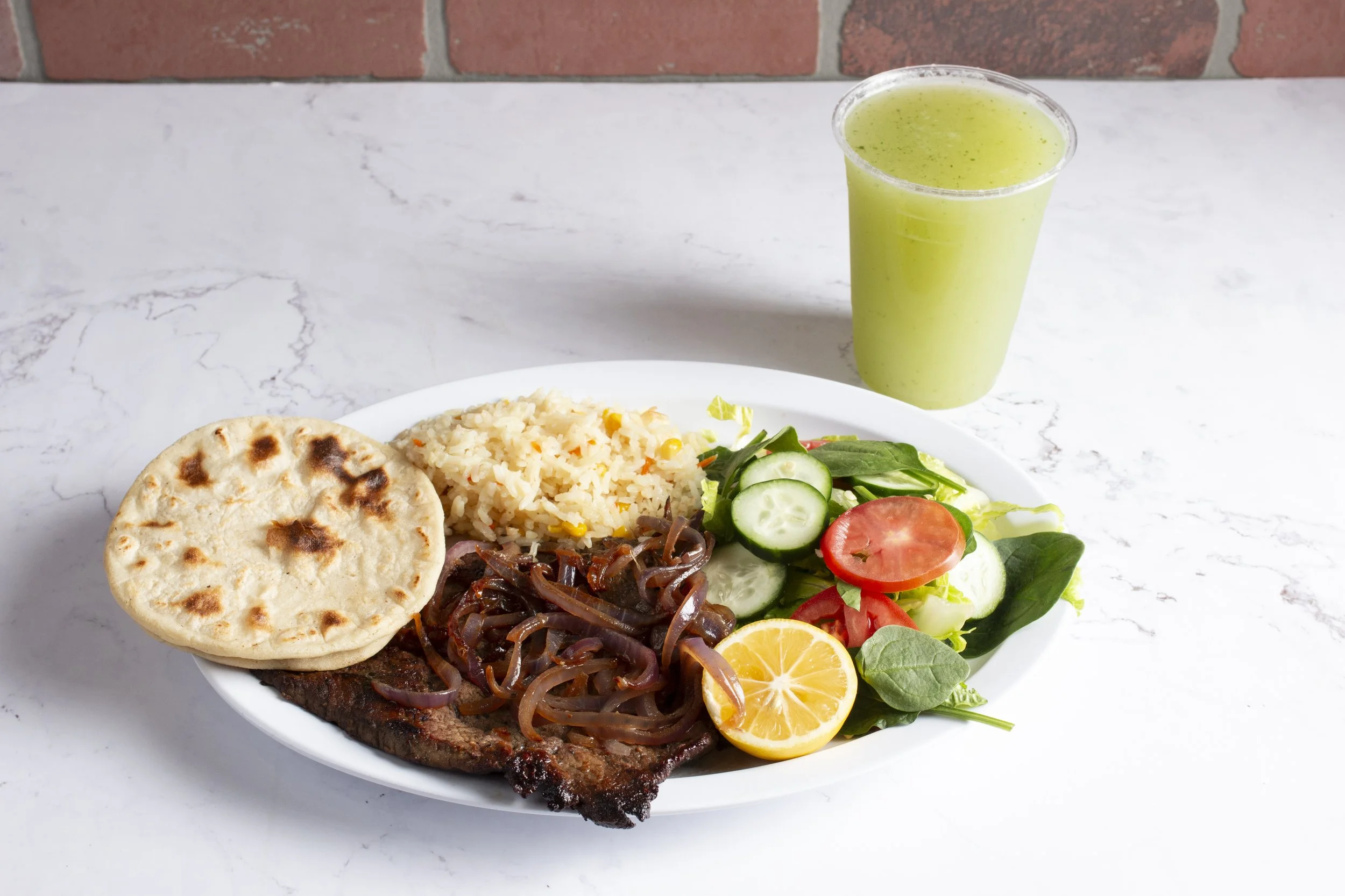 Carne Asada plate, served with fresh salad, rice and handmade tortillas