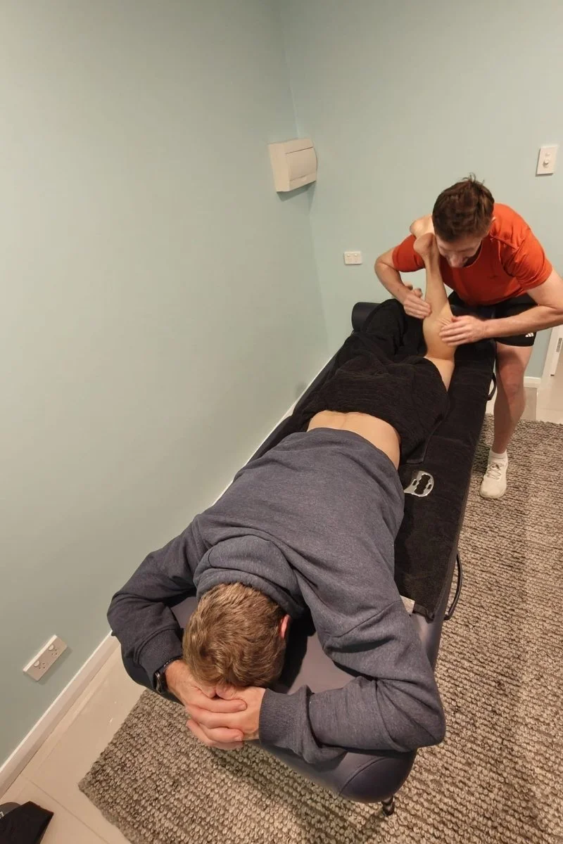 Luke massaging a client's calf