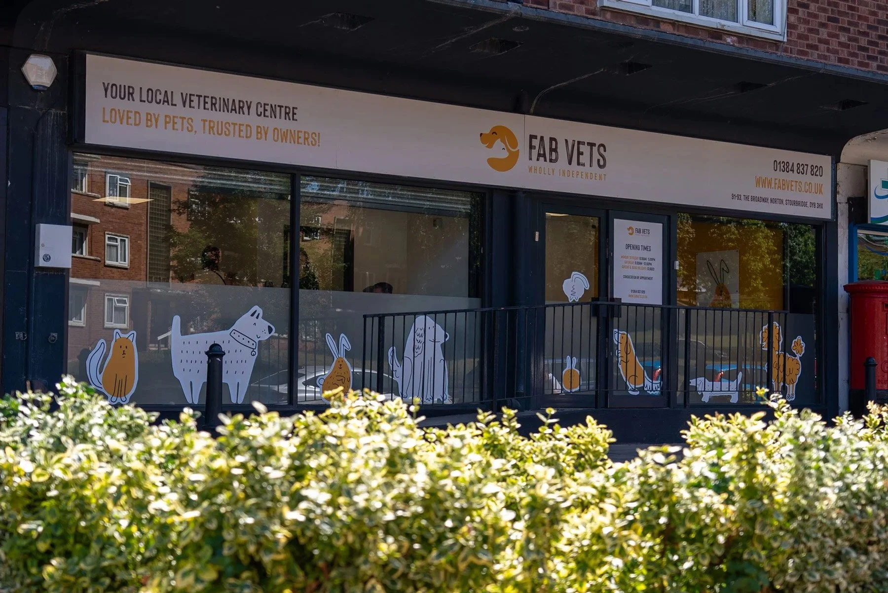 The exterior of Fab Vets, a local veterinary center, with cartoon pet illustrations on the windows.