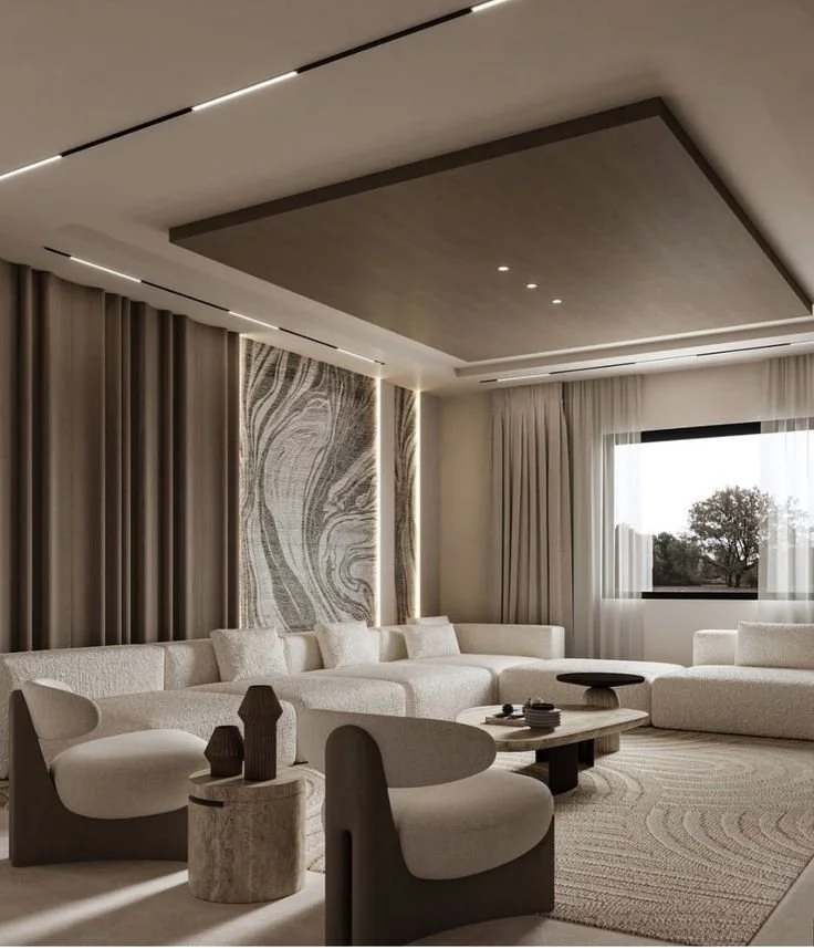 Modern living room with beige sectional sofa, decorative vases, and a large window with curtains, featuring a sleek ceiling design with recessed lighting.