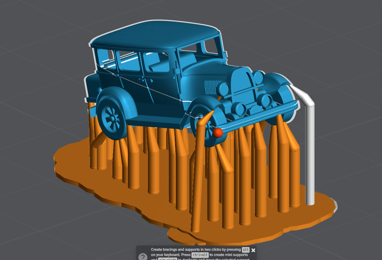 A model car has supports added in software prior to being 3D printed.