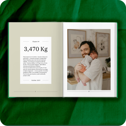 Krinkled printed family book open to chapter page showing father holding newborn baby with story text