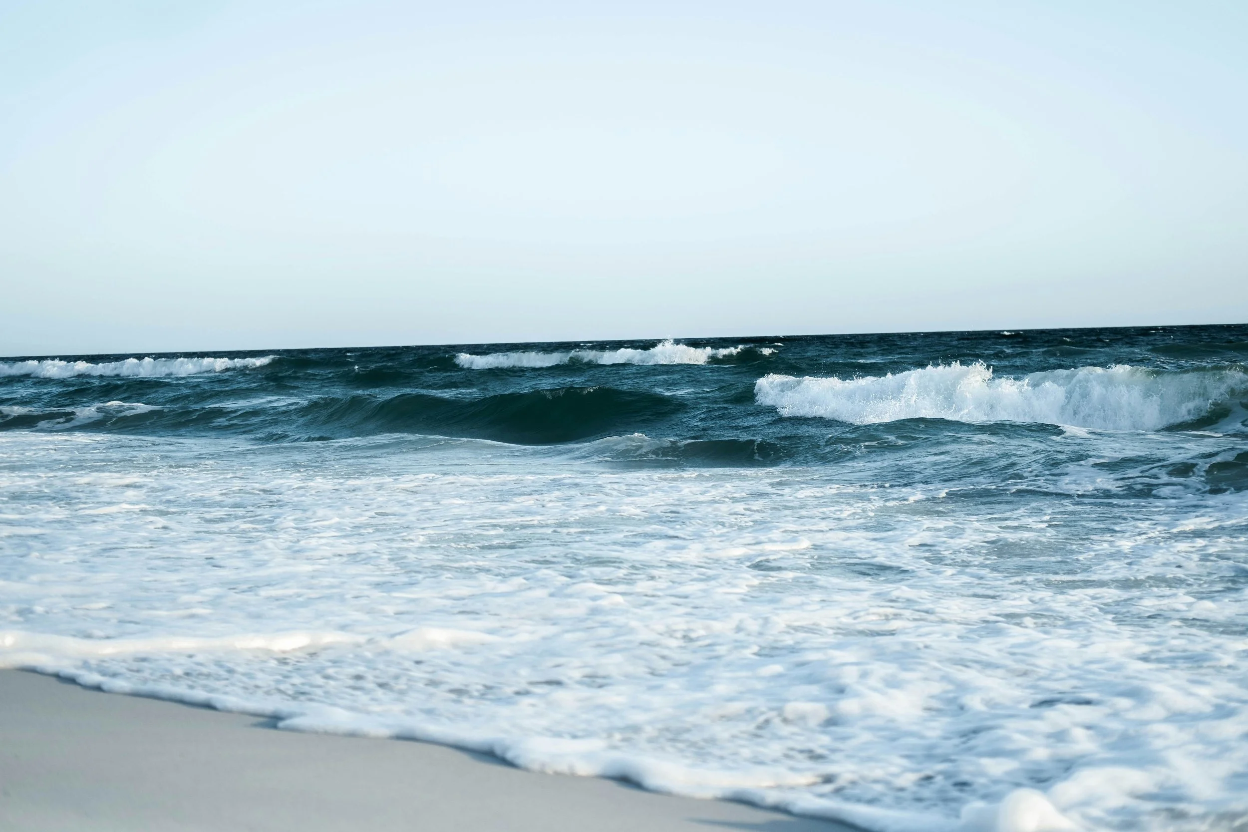 Ocean waves crashing onto a rocky shoreline.