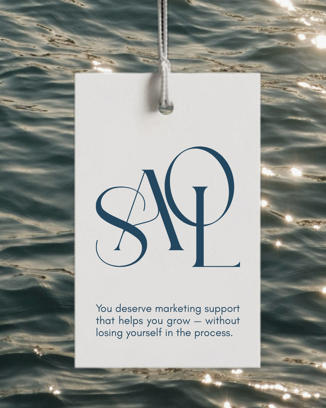 A marketing support sign hanging over water with the quote: 'You deserve marketing support that helps you grow — without losing yourself in the process.'