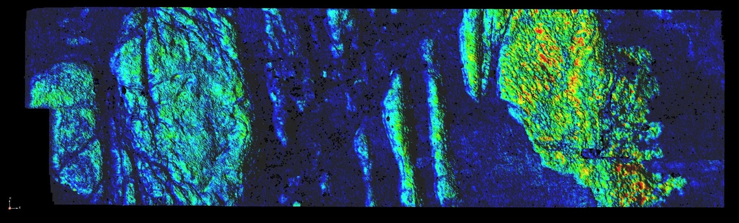 Heat map of a microscopic or geological sample with blue, green, yellow, and red colors indicating different intensities or values.