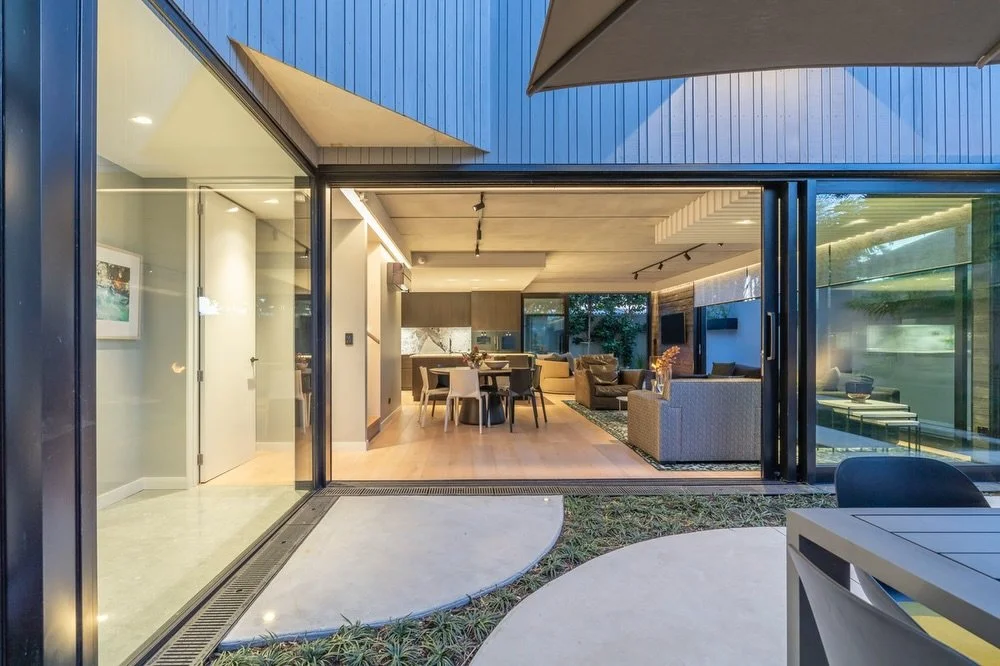 A Westmere courtyard built for connection &mdash; simple lines, warm tones and seamless flow from inside to out.