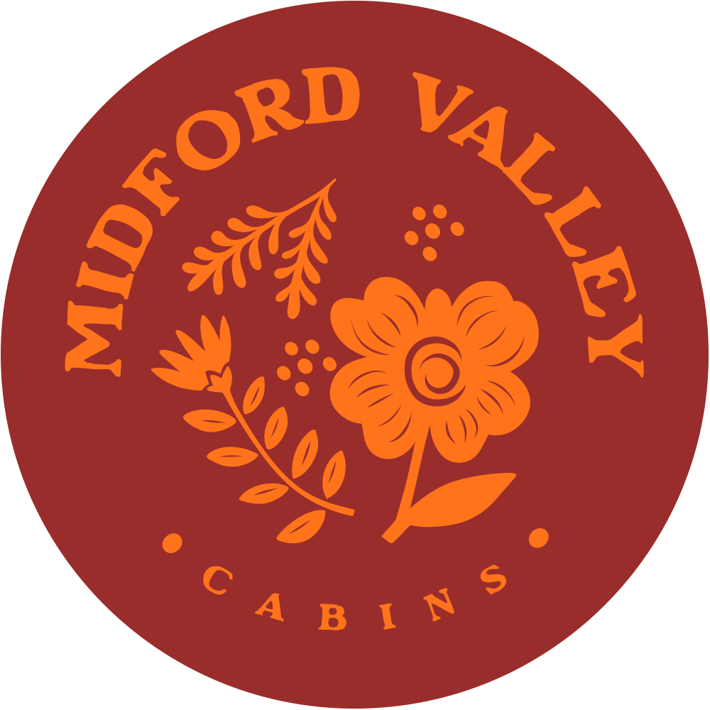 Logo for Midford Valley Cabins featuring an orange flower and foliage design on a brown circular background.