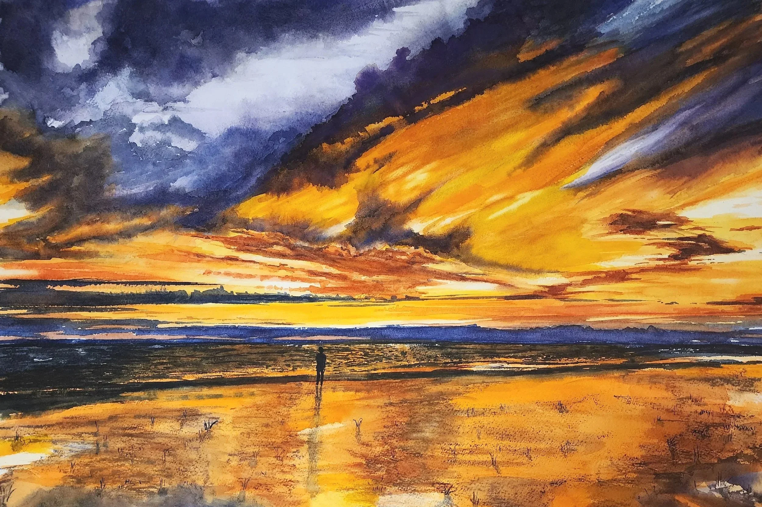 A vibrant watercolor painting of a sunset over a beach, with dramatic clouds in shades of blue, purple, orange, and yellow, and a solitary person standing on the wet sand reflecting the colors of the sky.