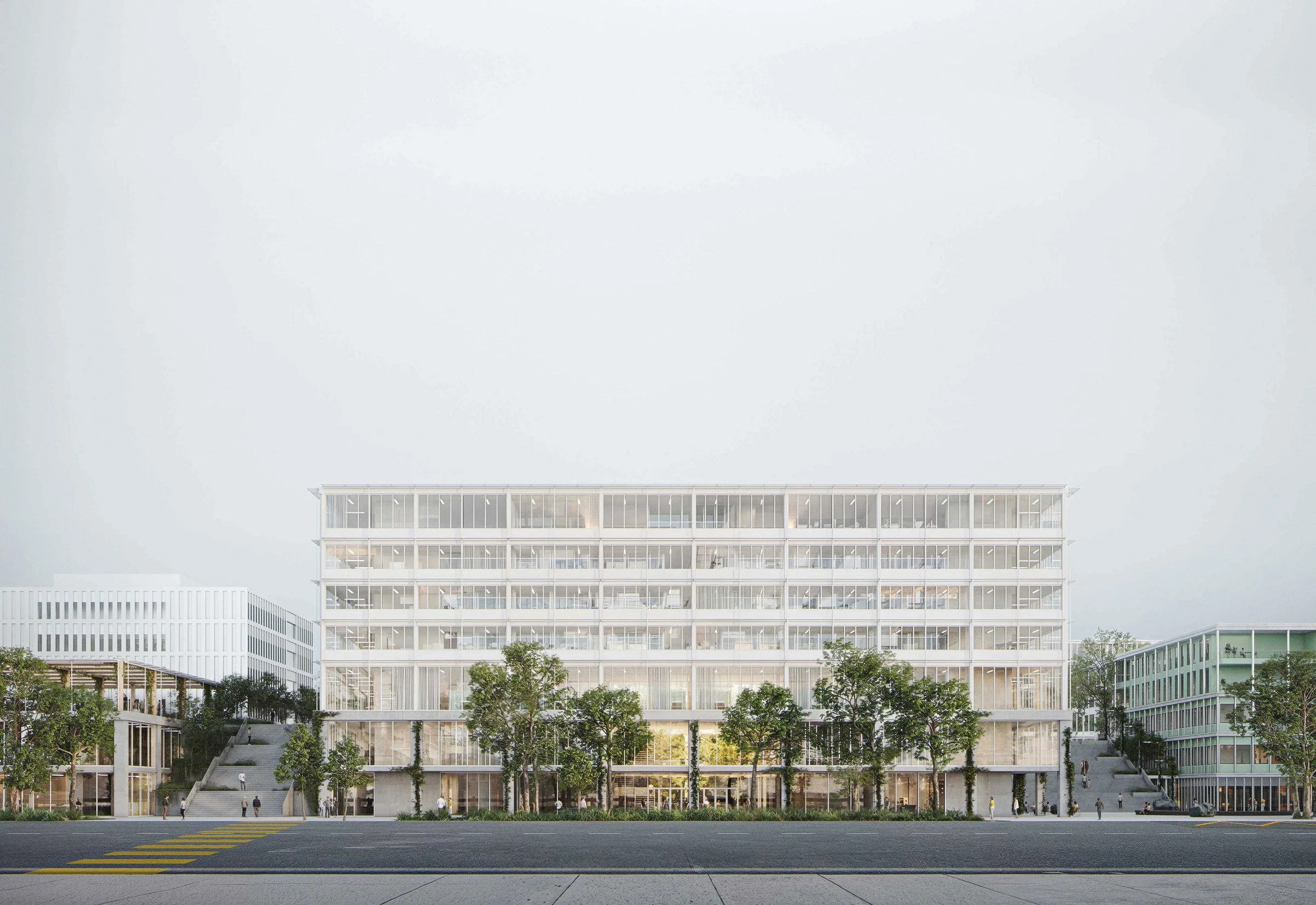 Modernes, weißes Bürogebäude mit vielen Fenstern, umgeben von Bäumen, auf einem Stadtstraßenabschnitt