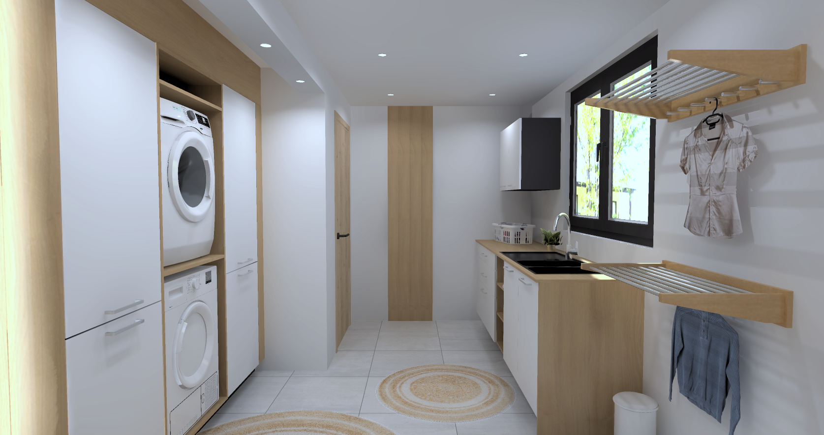 Une buanderie moderne avec lave-linge, sèche-linge, évier, armoires blanches et étagères en bois, un meuble de rangement, une fenêtre laissant entrer la lumière, et des étagères pour suspendre des vêtements.