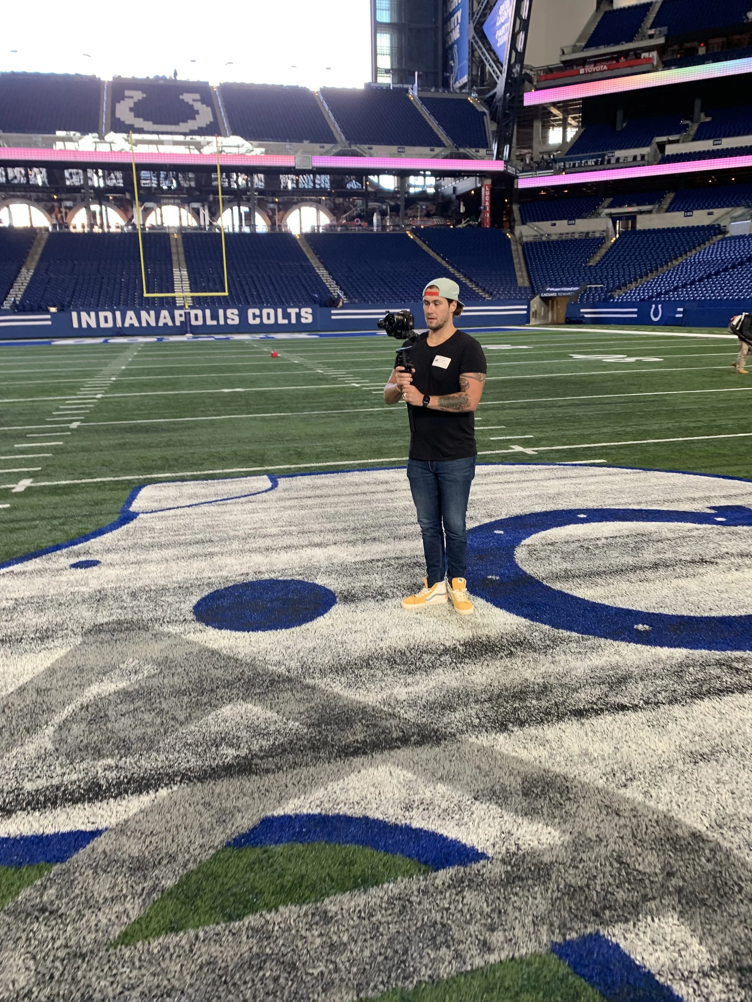 Kyle Williams filming on the field at Lucas Oil Stadium