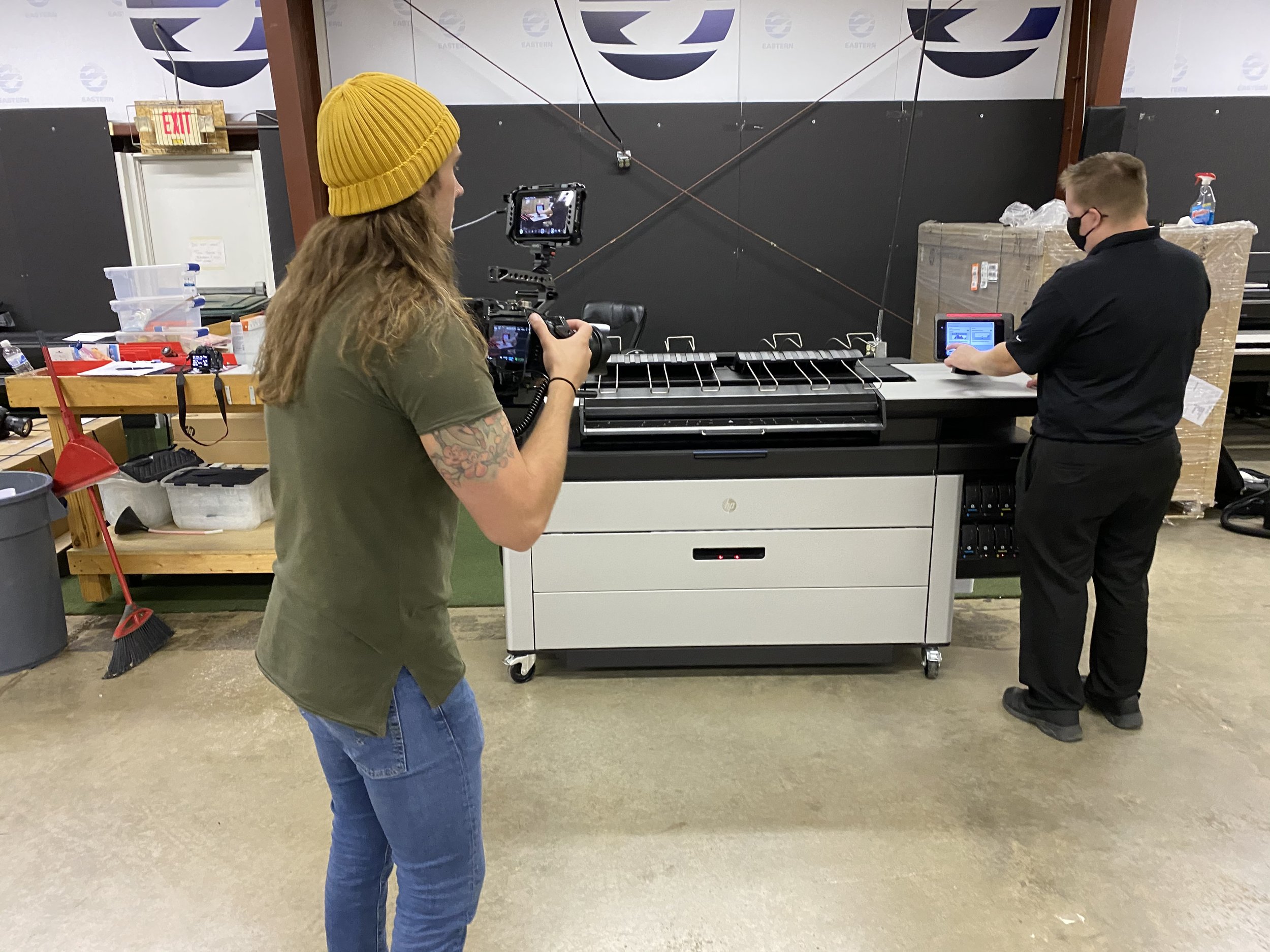 Bone Hook Media filming on location, warm workshop light