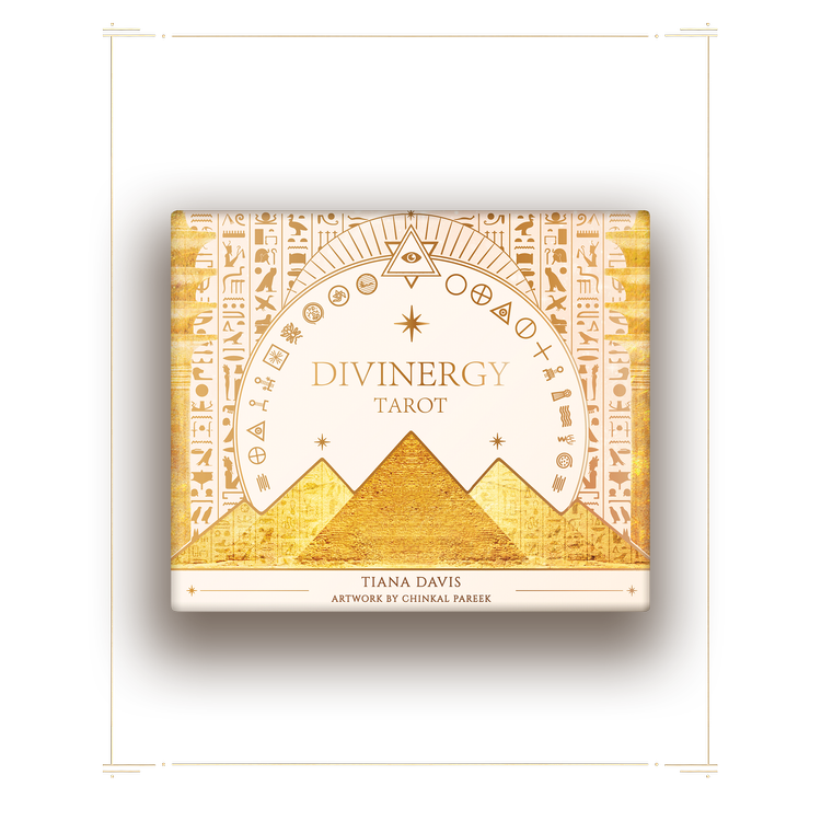 The cover of a divinergy tarot deck featuring golden pyramids and symbols with a celestial background.