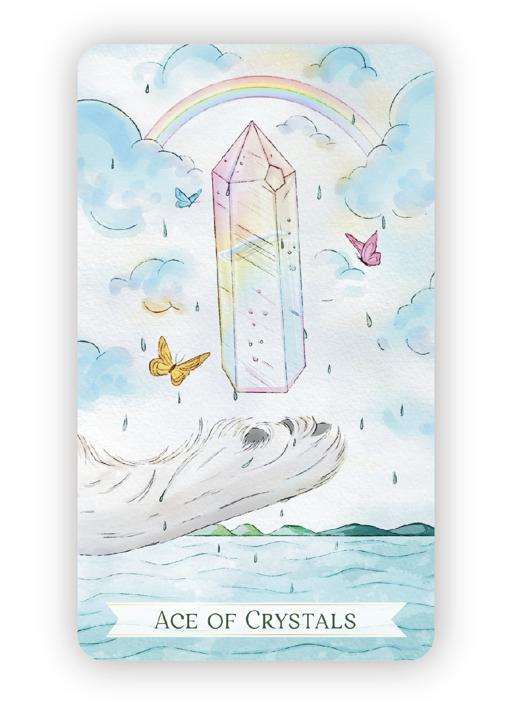 Watercolor illustration of a large, transparent crystal with a rainbow above it, clouds, raindrops, and colorful butterflies surrounding it, with water and distant islands below. The text "Ace of Crystals" is at the bottom.