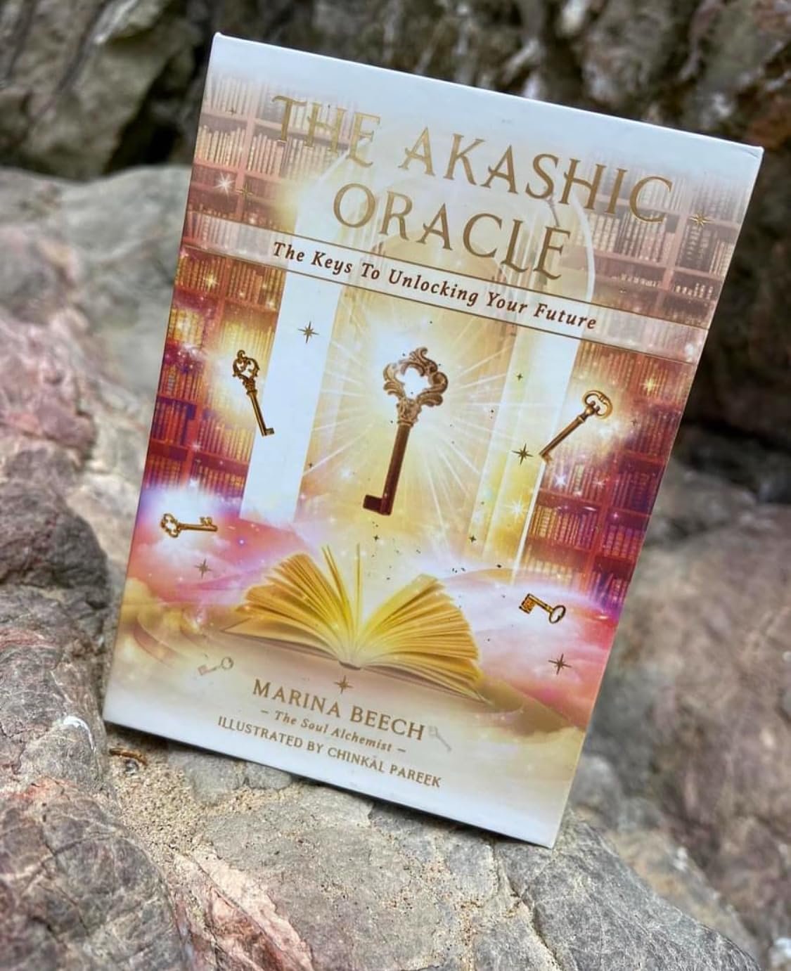 The Akashic Oracle book cover with keys, an open book, and glowing library background.