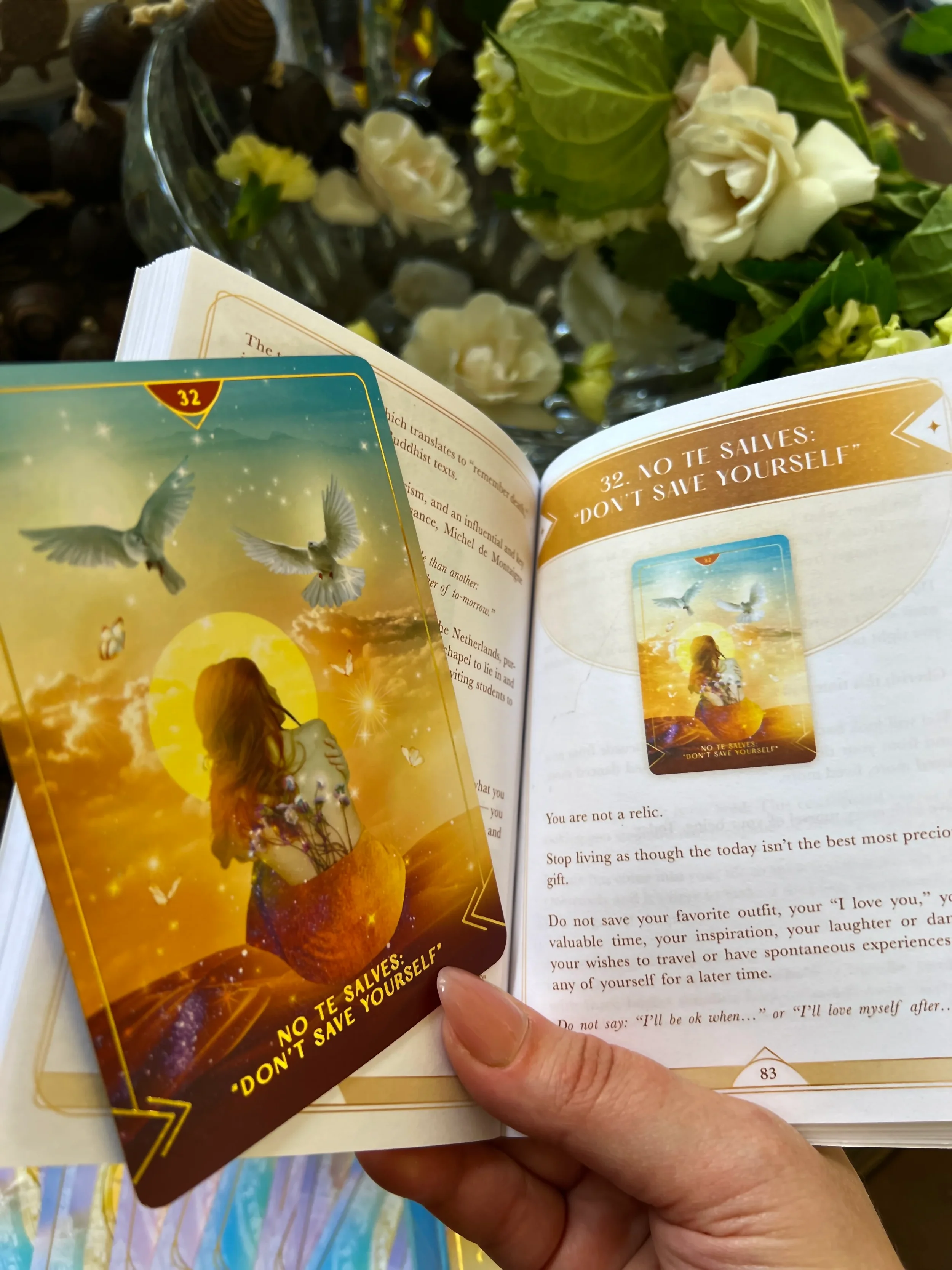 Card featuring a woman with long hair, sitting on a peach, surrounded by butterflies, with white doves flying in a yellow sunset sky.