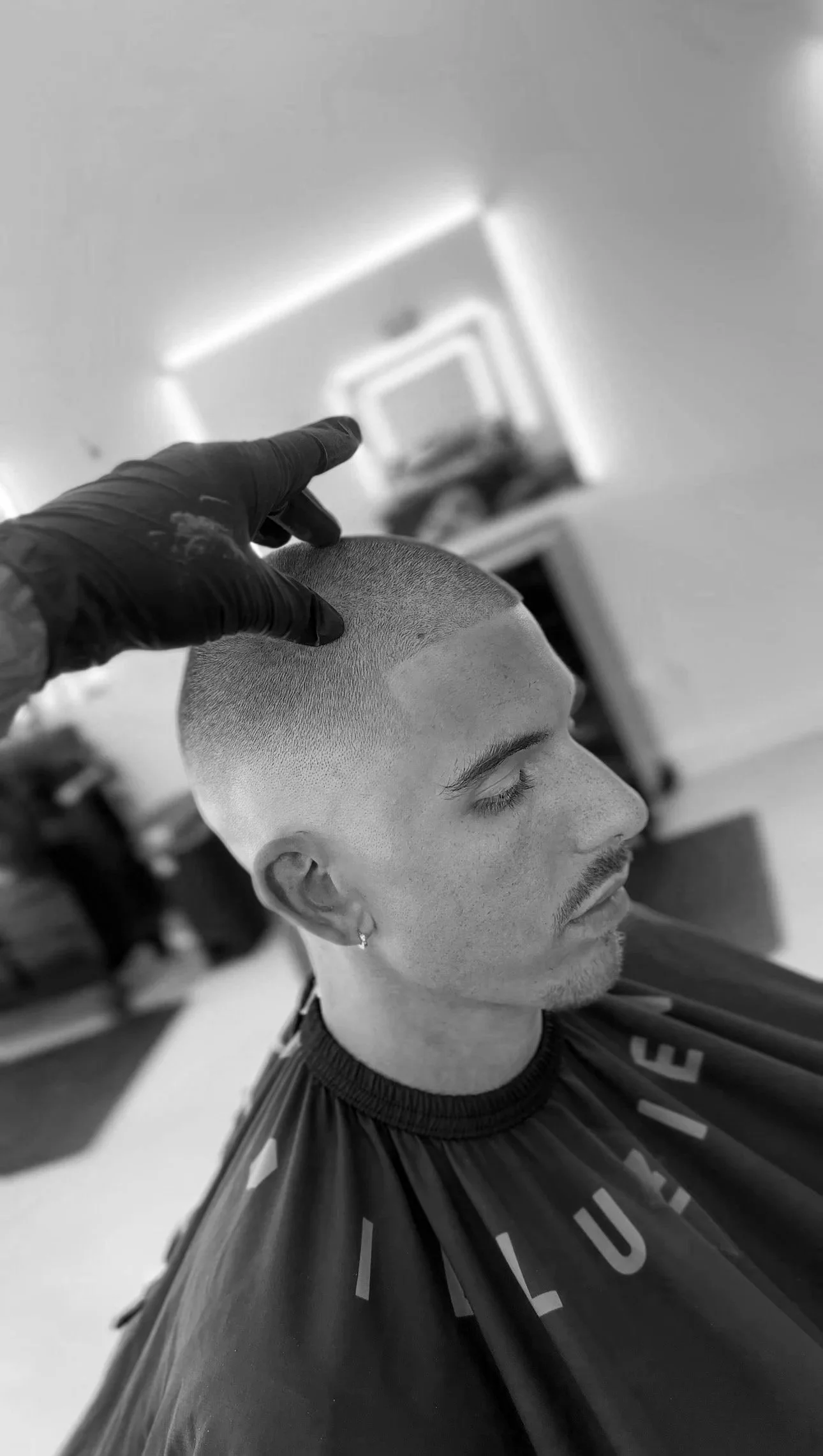 Man getting a buzz haircut at the barber shop