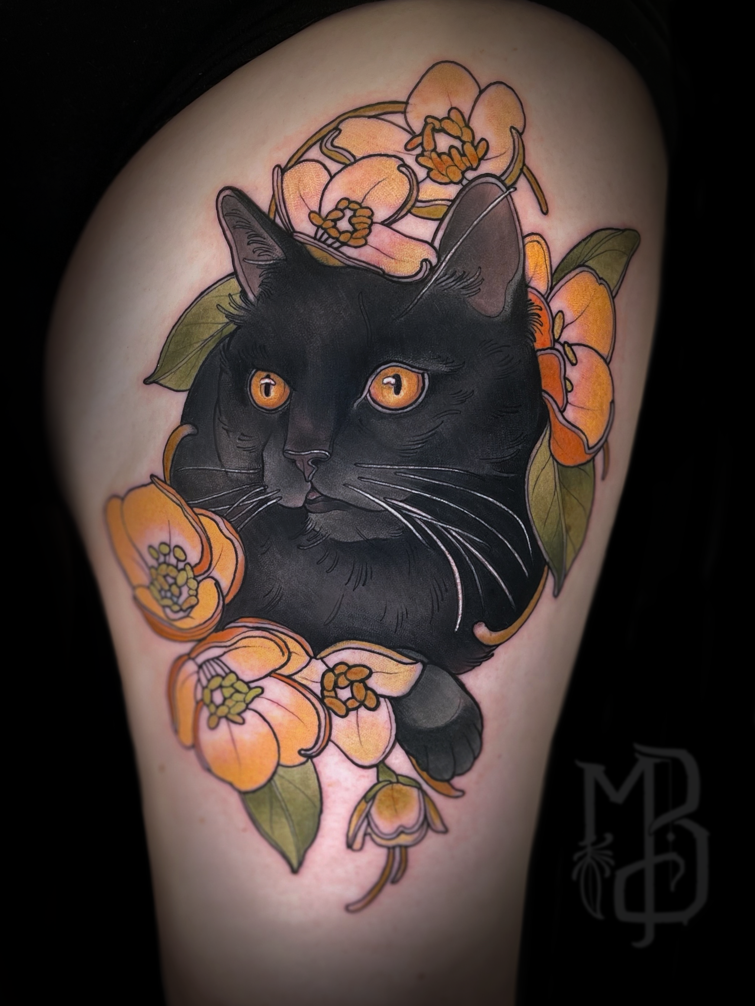 Tattoo of a black cat portrait with amber eyes surrounded by orange and pink flowers and green leaves.