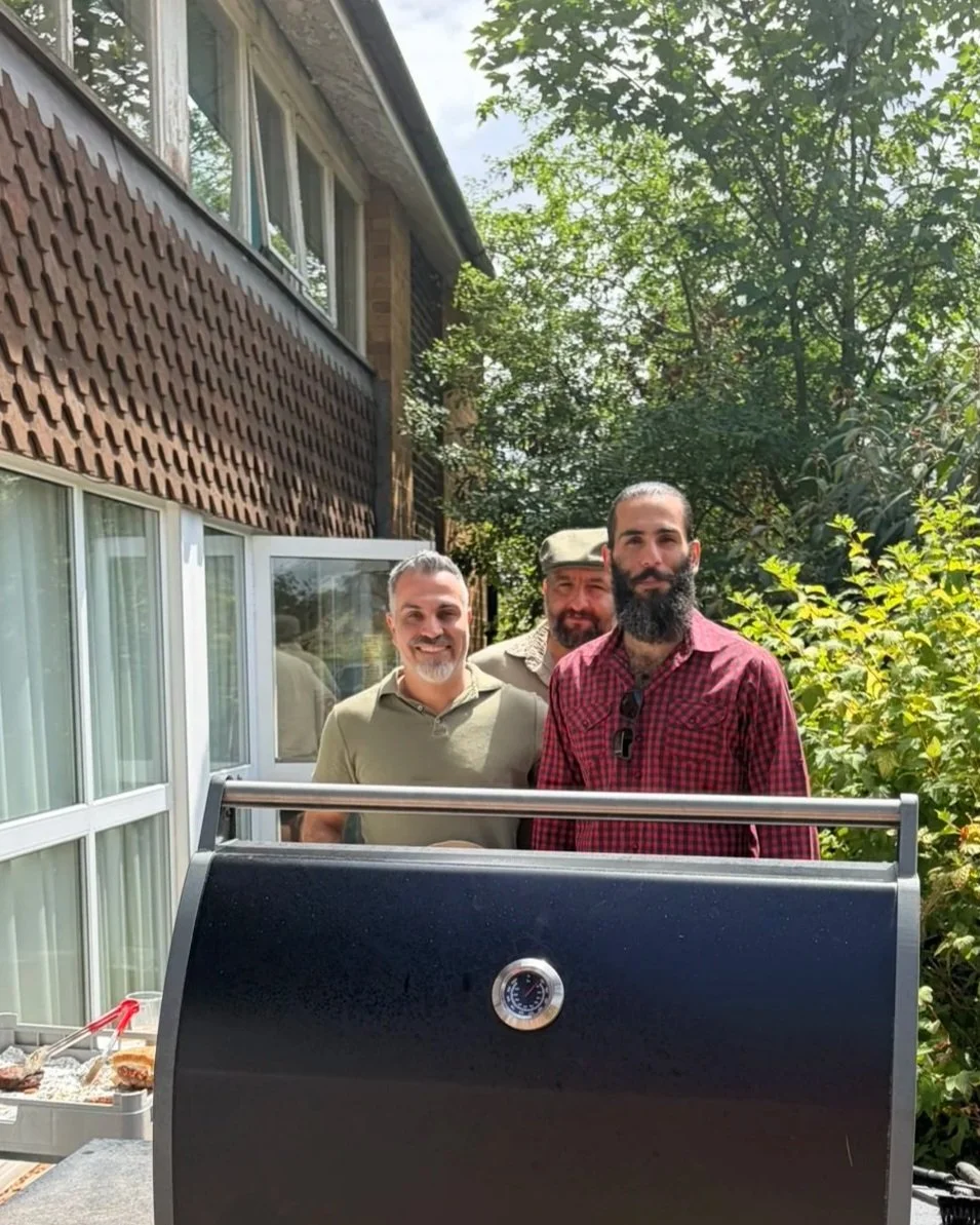 Father Jonathan Samedi with friends at the parish BBQ 