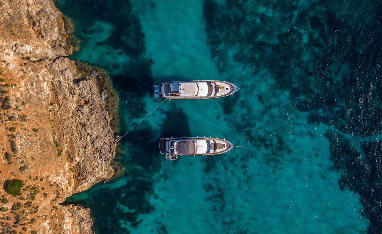 Yacht anchored in blue water in Greece