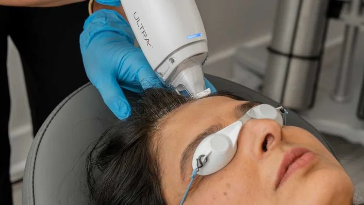 A patient wearing protective eyewear during an Ultra Laser treatment