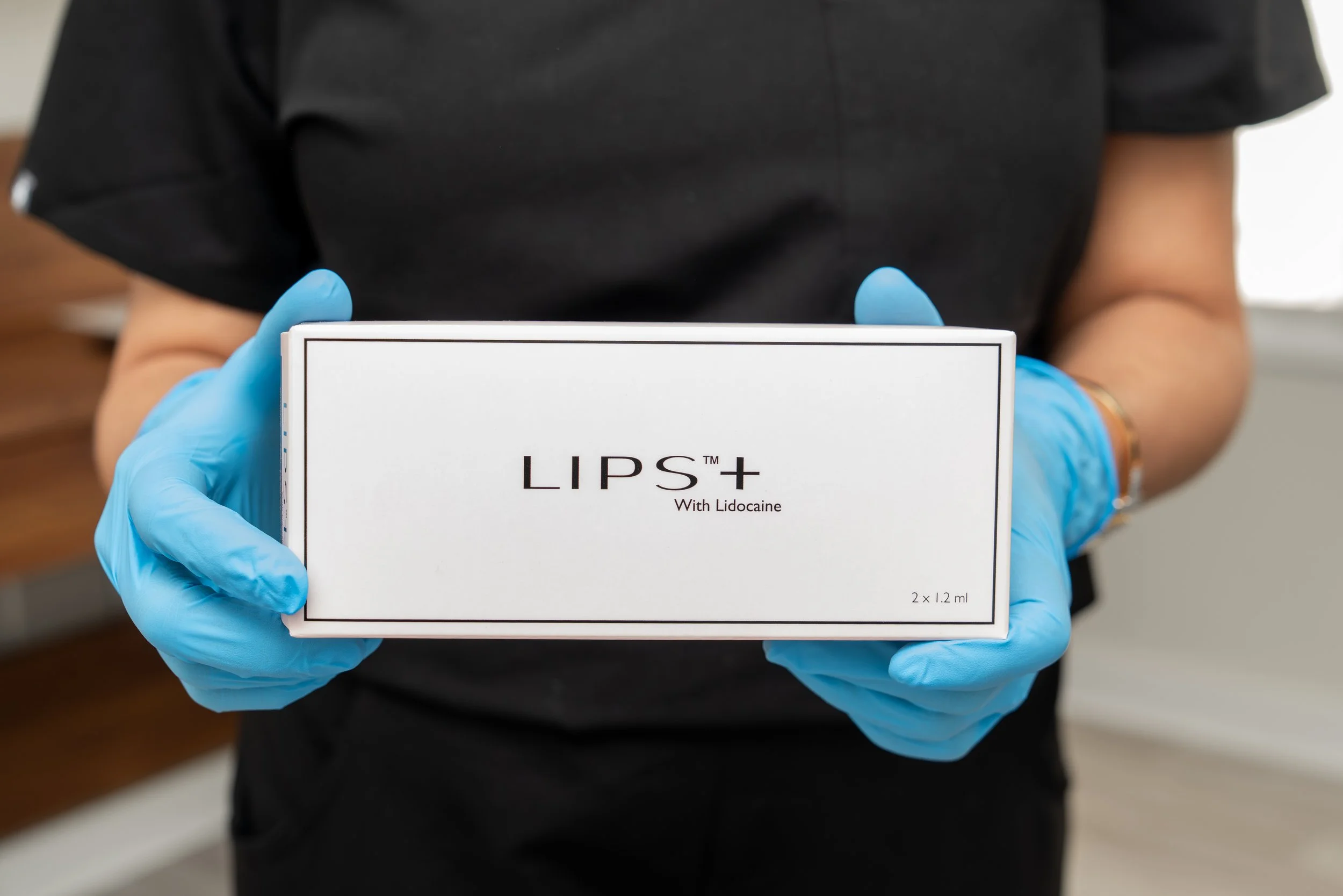 Dr. Neera holding a box of LIPS+ by Revanesse