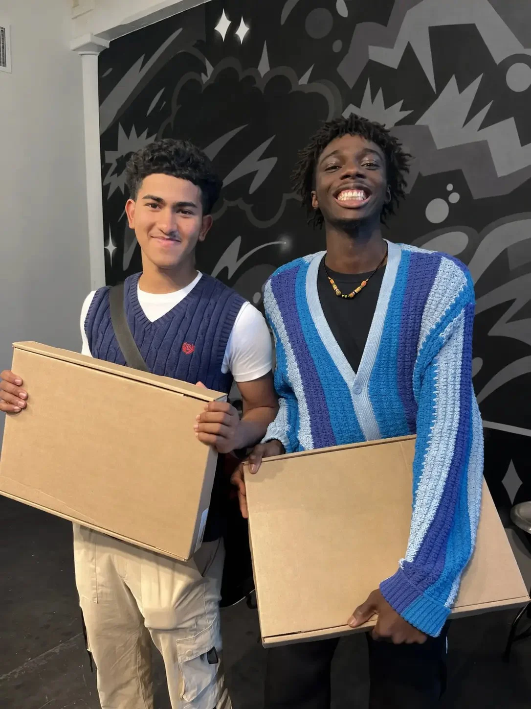 Two young participants being recognized at a community event