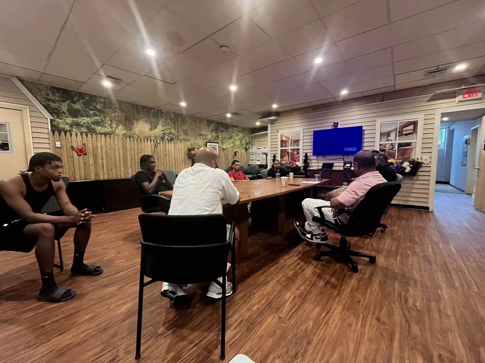LeBron Legacy founder leading a professional training session around a conference table