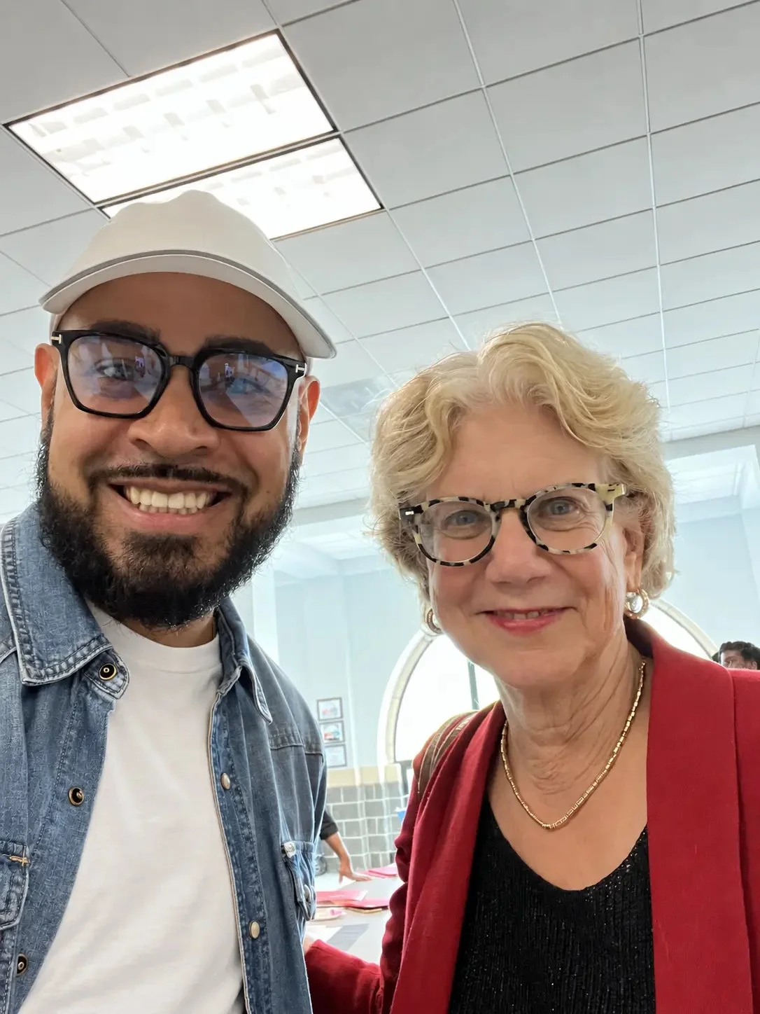 LeBron Legacy founder smiling with a community supporter at an event