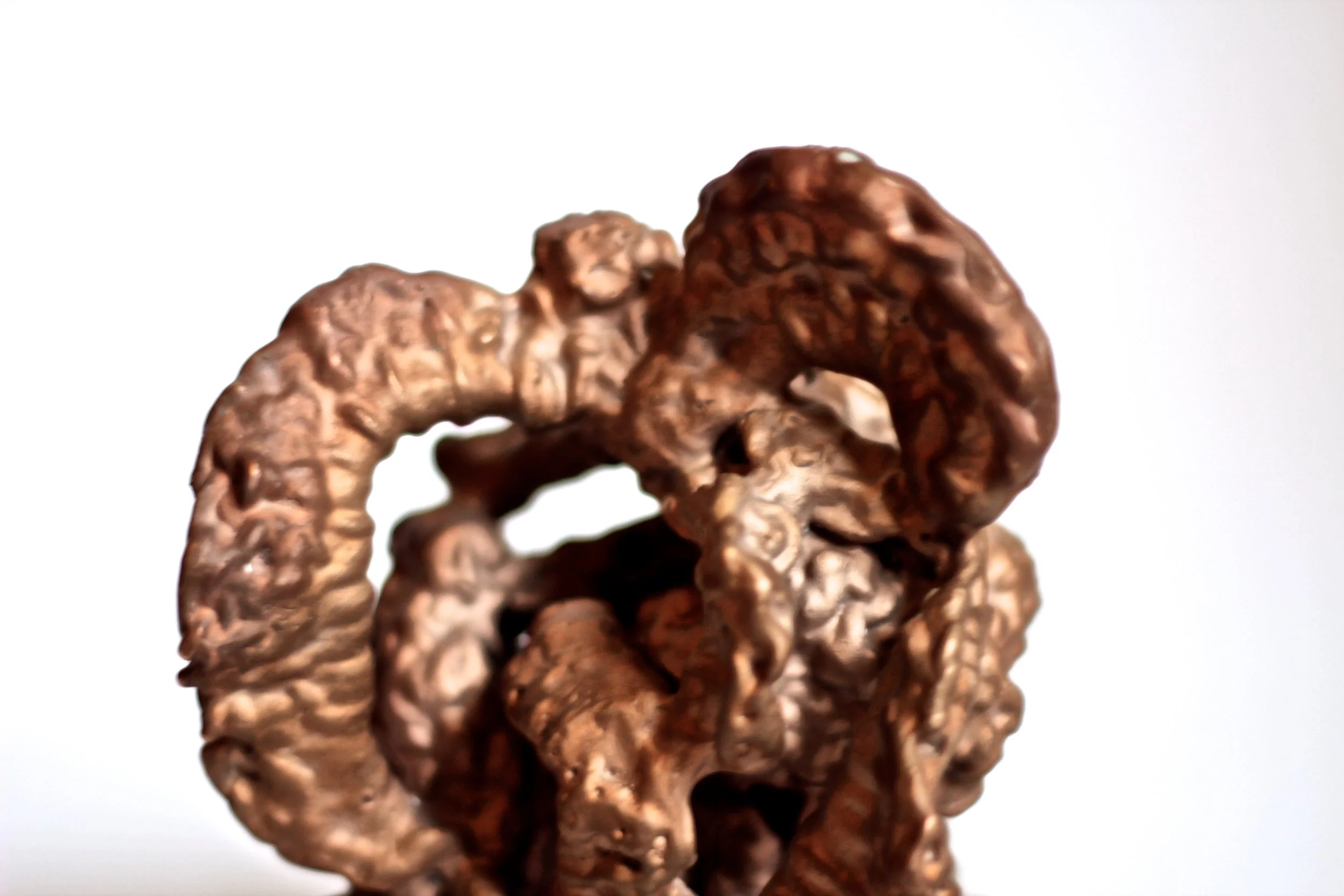 Close-up of a stack of chocolate cereal loops on a white background.