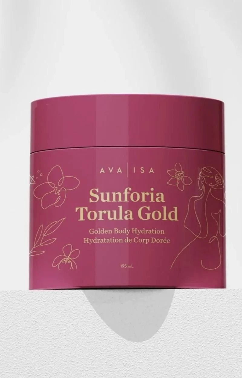 A pink container labeled 'Sunforia Torula Gold' for body hydration, with illustrations of flowers and a woman on the packaging.
